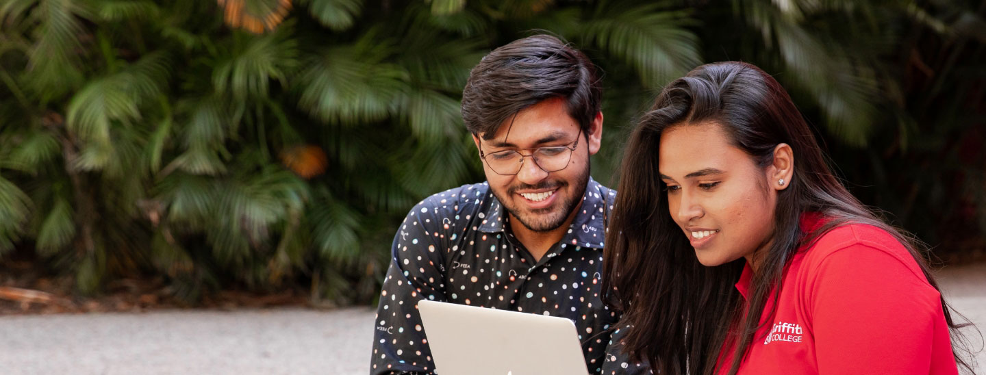 Students sitting on campus working together
