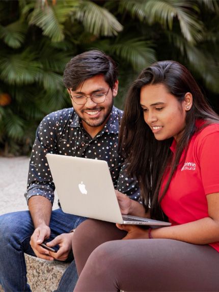Students sitting on campus working together