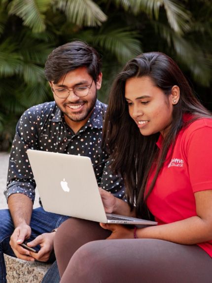Students sitting on campus working together