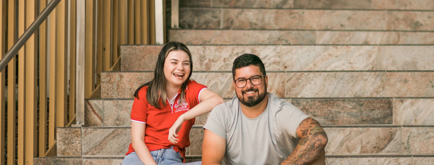 Students sitting stairs happy together
