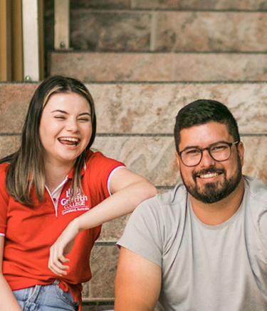 Students sitting stairs happy together
