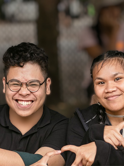 Students sitting outside happy together