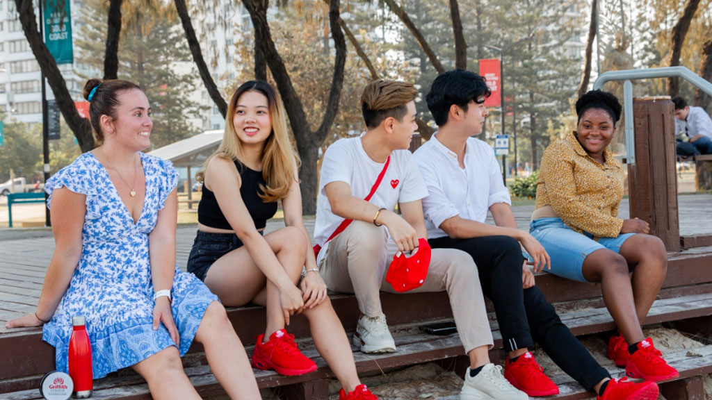Students sitting together beach