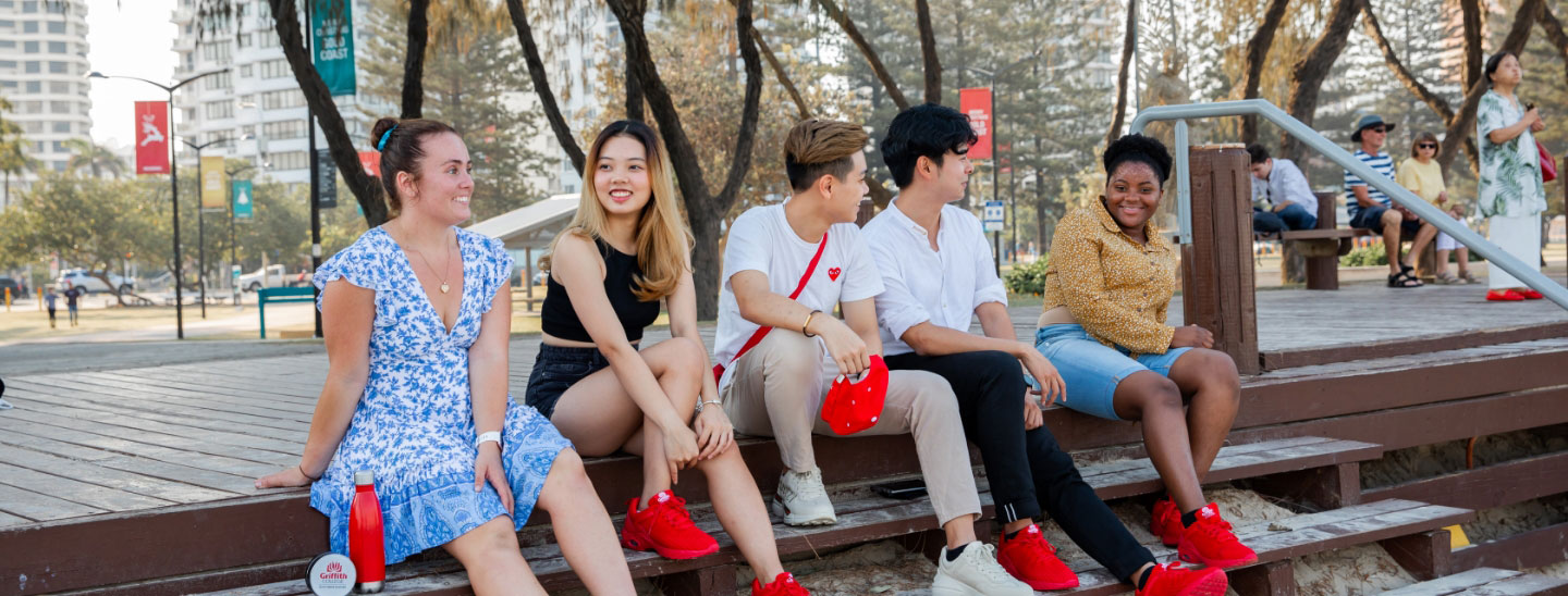 Students sitting together beach