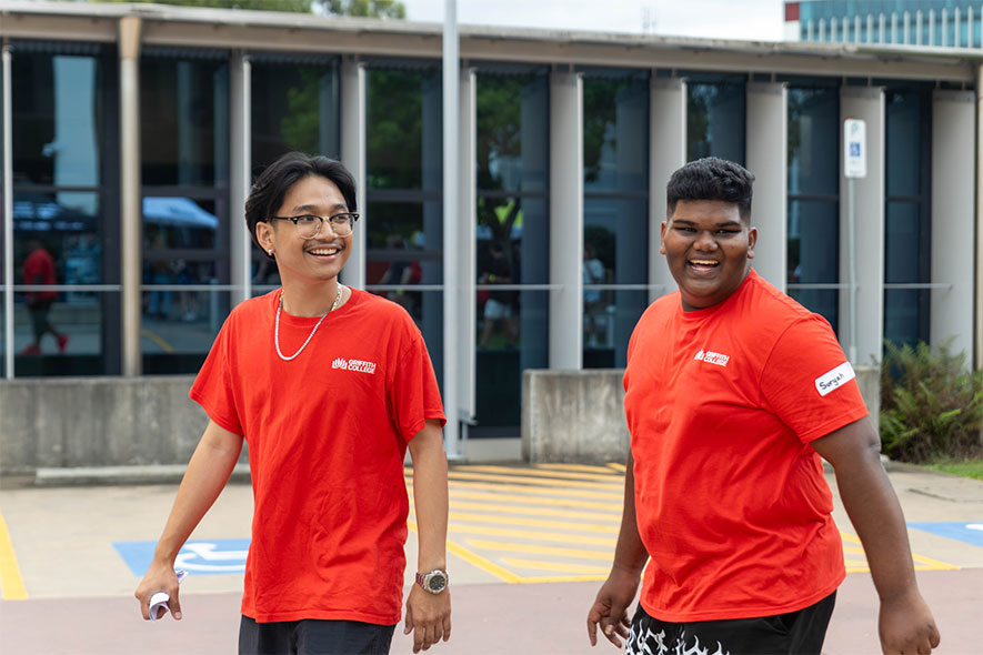 Students smiling and walking outside