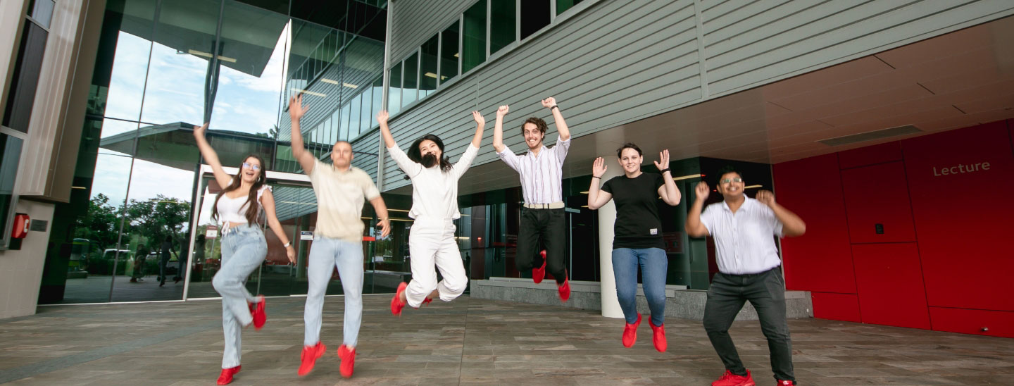 Students together jumping happy