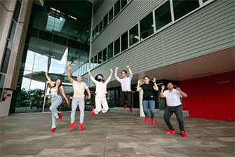 Students together jumping happy