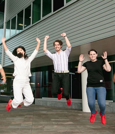 Students together jumping happy