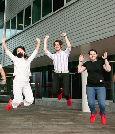 Students together jumping happy