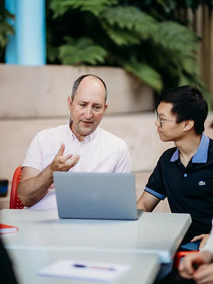 Student talking with teacher in the classroom