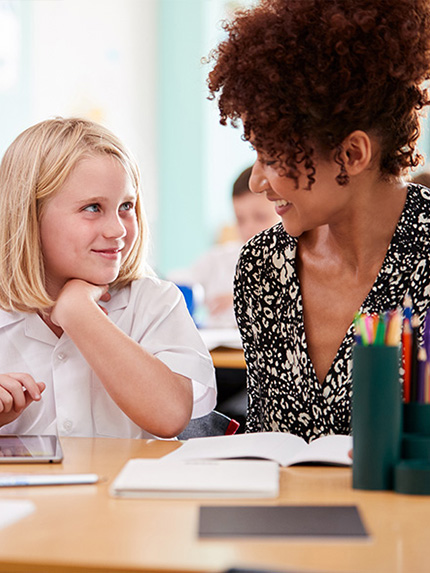 Teacher and student talking in the classroom