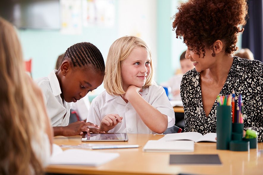 Teacher sitting in the class room with students